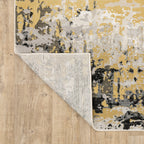 Abstract distressed rug with gold, black, and cream tones, worn texture design