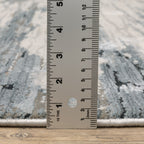 Modern grey and cream striped rug with distressed texture and abstract horizontal pattern