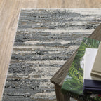 Modern grey and cream striped rug with distressed texture and abstract horizontal pattern