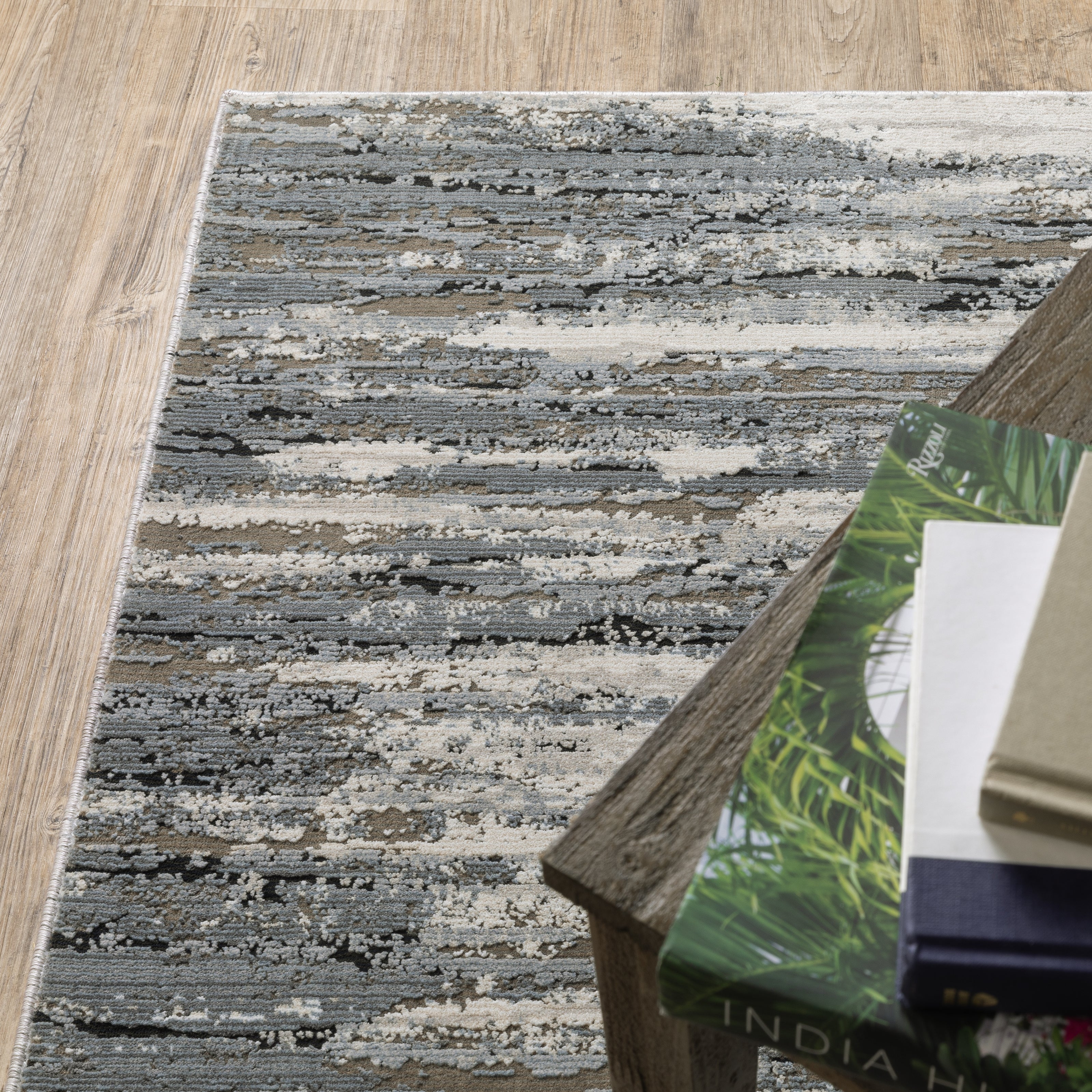 Modern grey and cream striped rug with distressed texture and abstract horizontal pattern