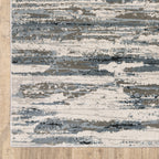 Modern grey and cream striped rug with distressed texture and abstract horizontal pattern