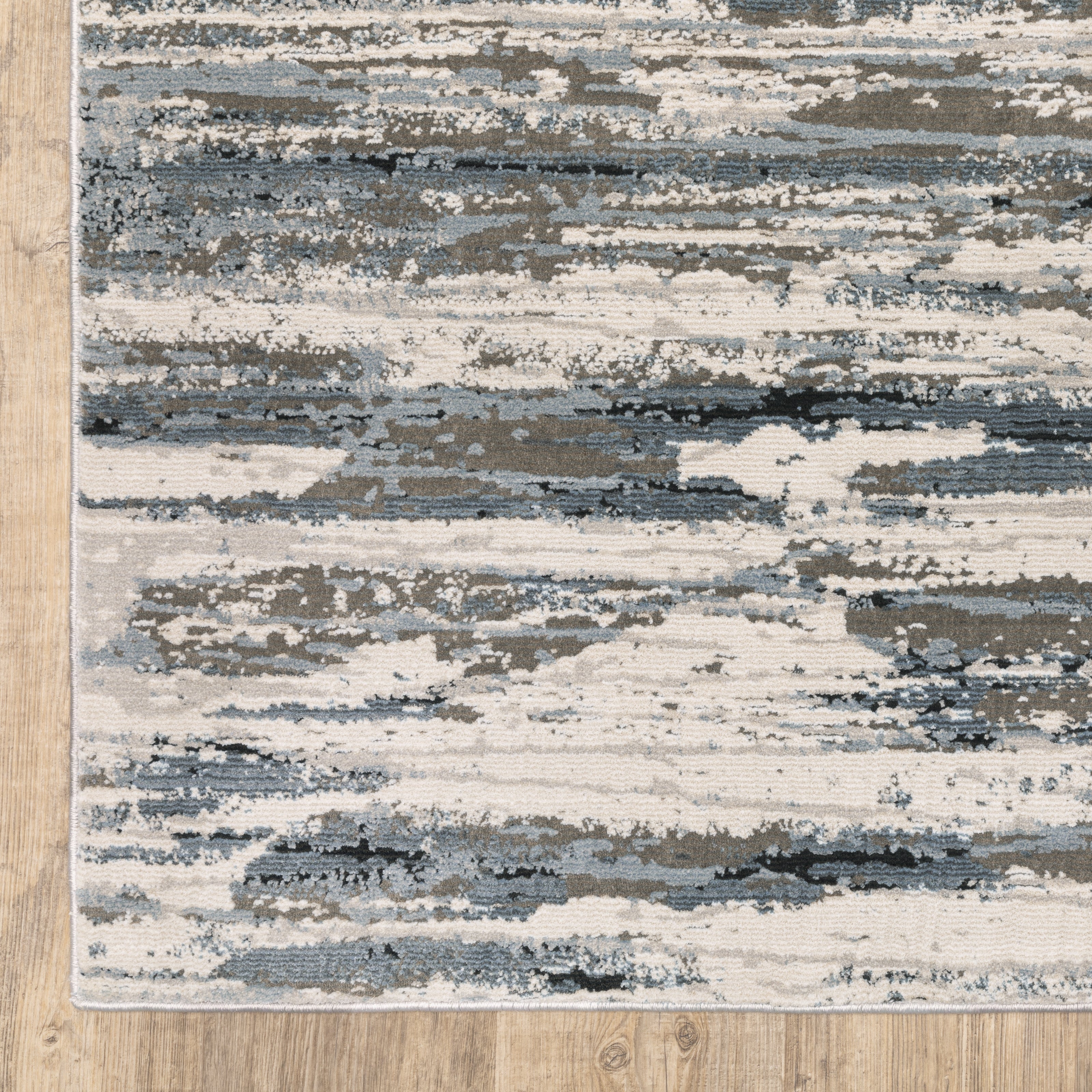 Modern grey and cream striped rug with distressed texture and abstract horizontal pattern