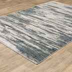 Modern grey and cream striped rug with distressed texture and abstract horizontal pattern