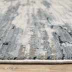 Modern grey and cream striped rug with distressed texture and abstract horizontal pattern