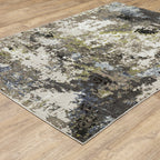 Abstract distressed area rug with grey, black, white and yellow splatter pattern