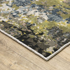 Abstract distressed area rug with grey, black, white and yellow splatter pattern