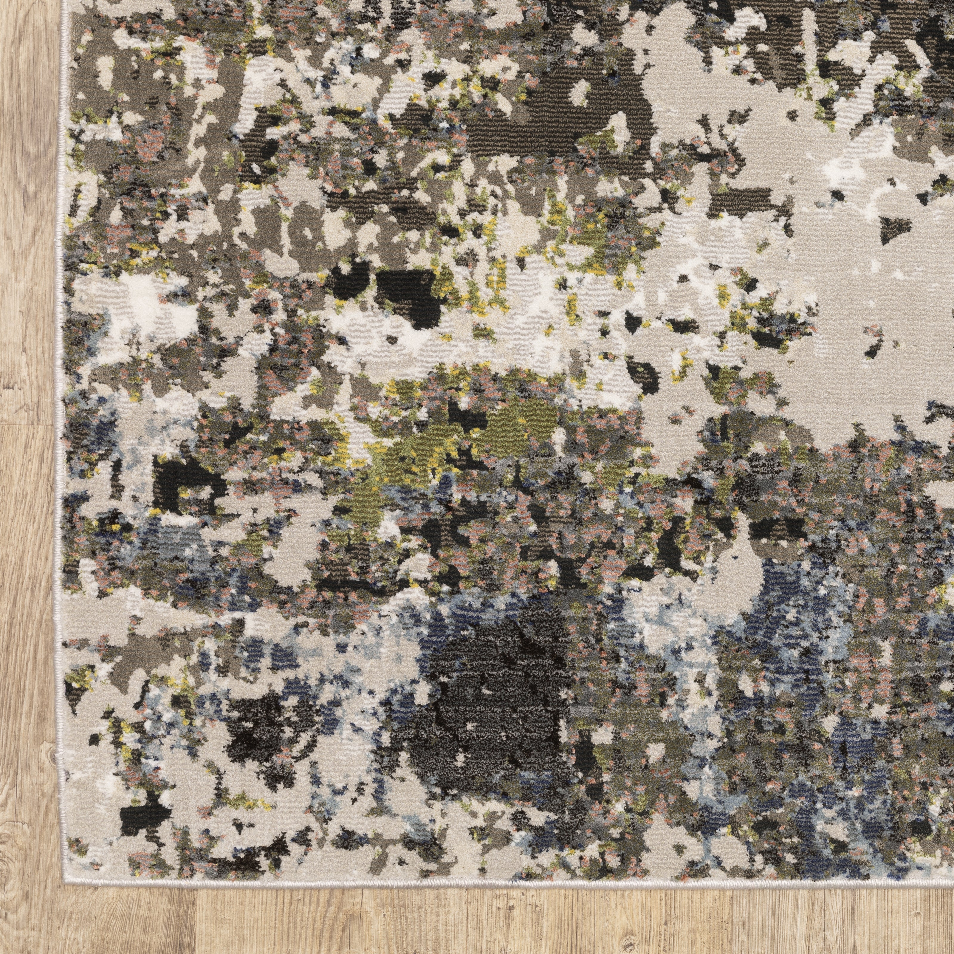 Abstract distressed area rug with grey, black, white and yellow splatter pattern