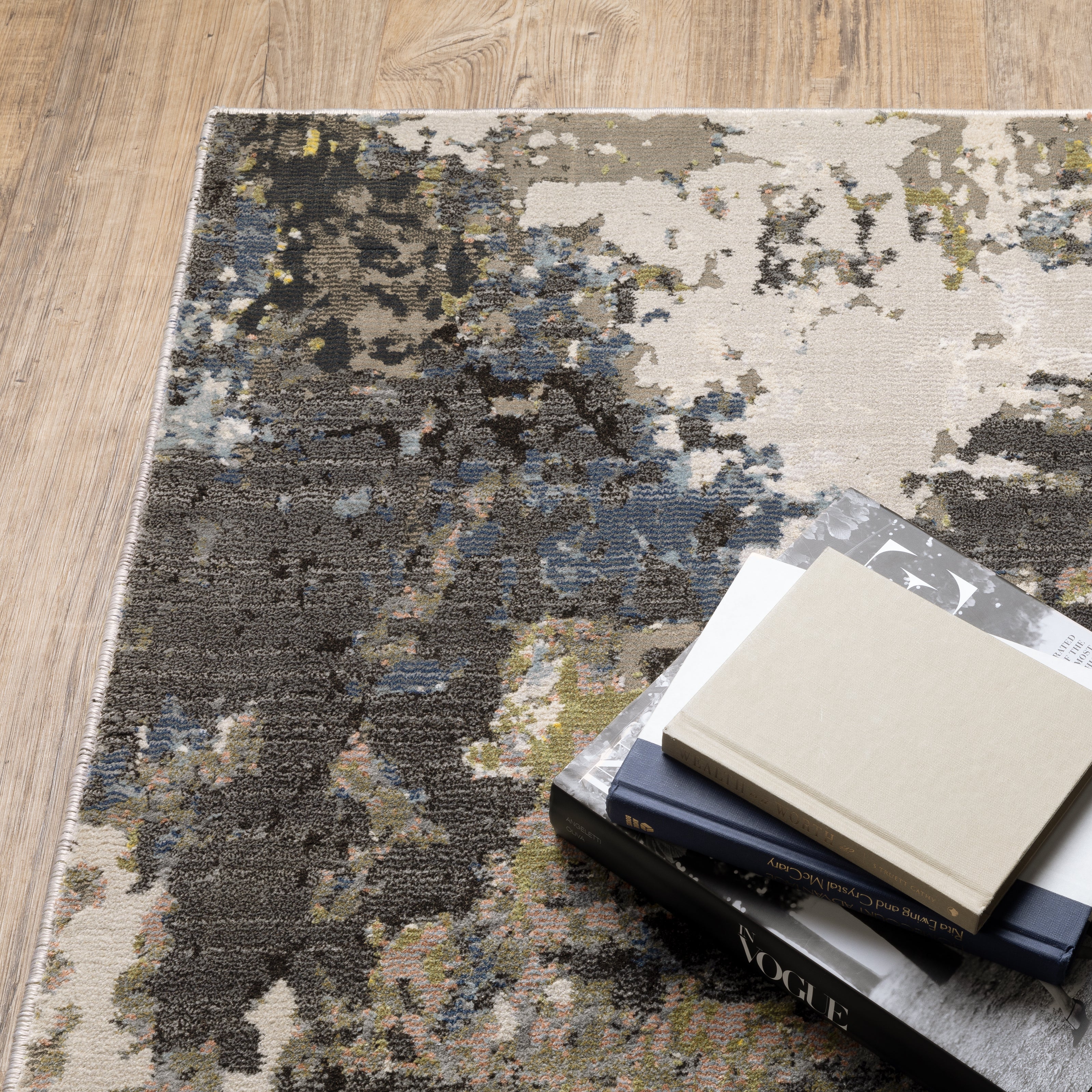 Abstract distressed area rug with grey, black, white and yellow splatter pattern