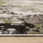 Abstract distressed area rug with grey, black, white and yellow splatter pattern