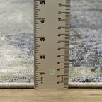 Abstract grey and cream distressed rug with textured weathered design