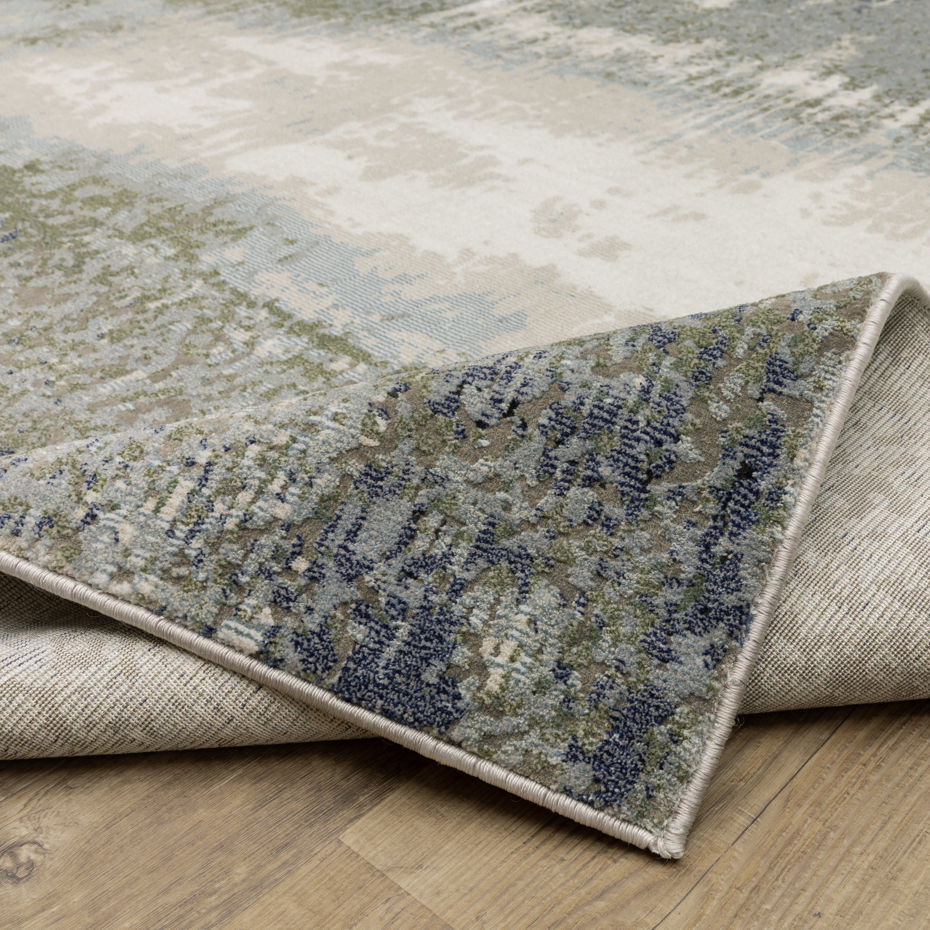 Abstract grey and cream distressed rug with textured weathered design