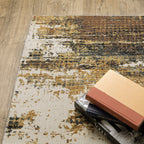 Distressed gold and cream abstract rug with vintage texture and weathered pattern design
