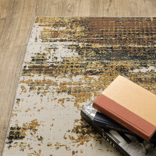 Distressed gold and cream abstract rug with vintage texture and weathered pattern design