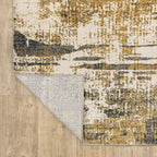 Distressed gold and cream abstract rug with vintage texture and weathered pattern design