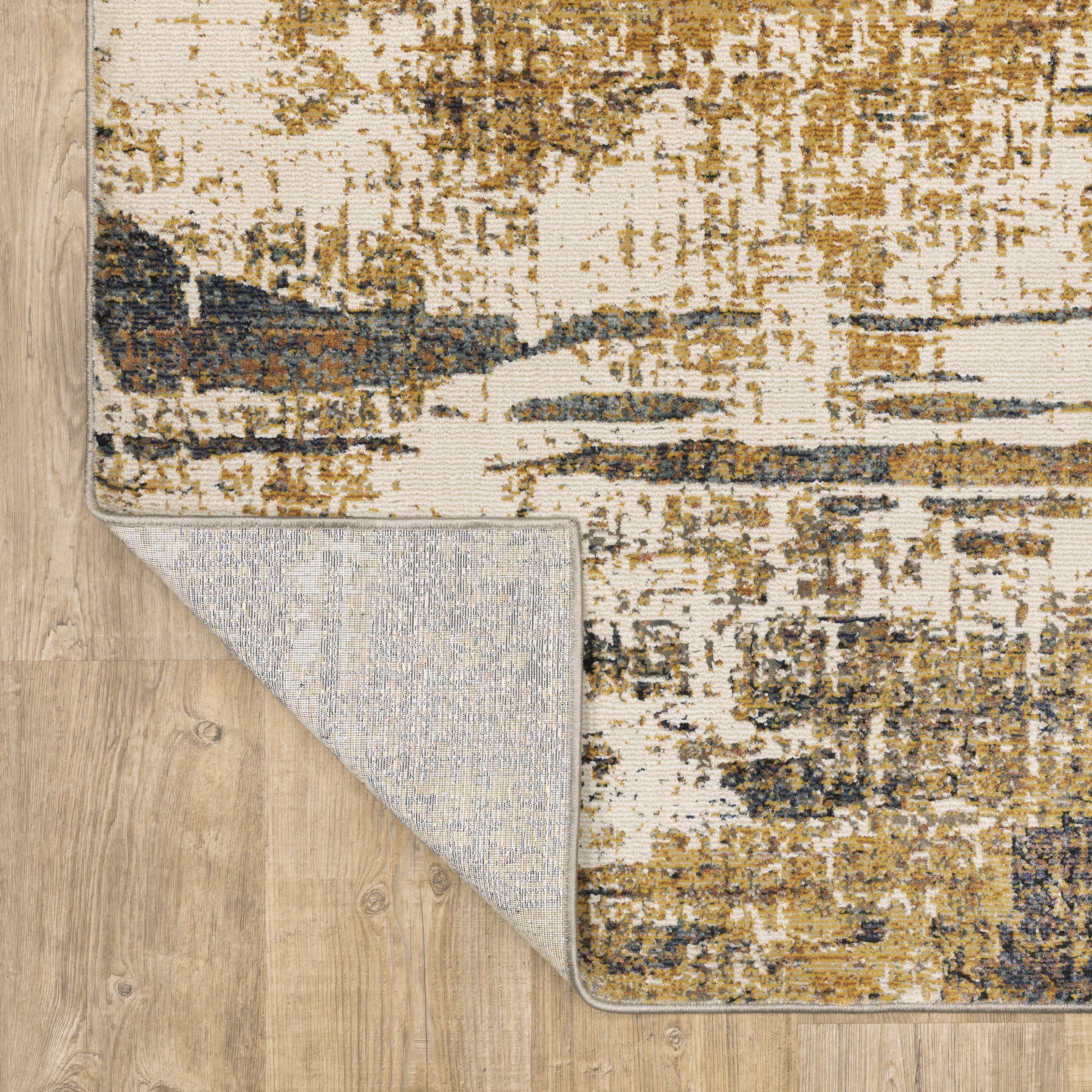 Distressed gold and cream abstract rug with vintage texture and weathered pattern design