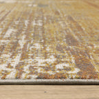 Distressed gold and cream abstract rug with vintage texture and weathered pattern design
