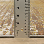 Distressed gold and cream abstract rug with vintage texture and weathered pattern design