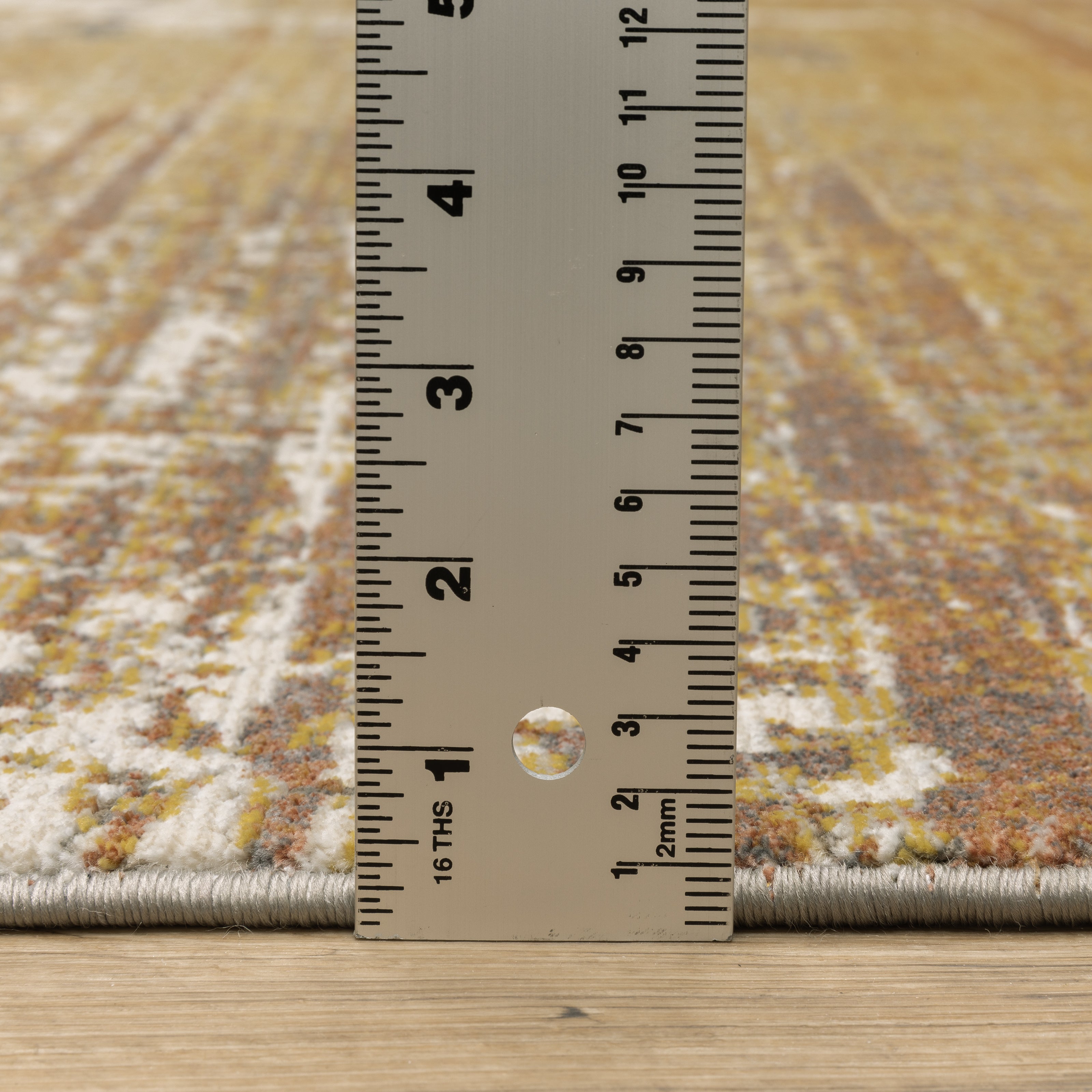 Distressed gold and cream abstract rug with vintage texture and weathered pattern design