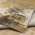 Distressed gold and cream abstract rug with vintage texture and weathered pattern design