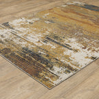 Distressed gold and cream abstract rug with vintage texture and weathered pattern design
