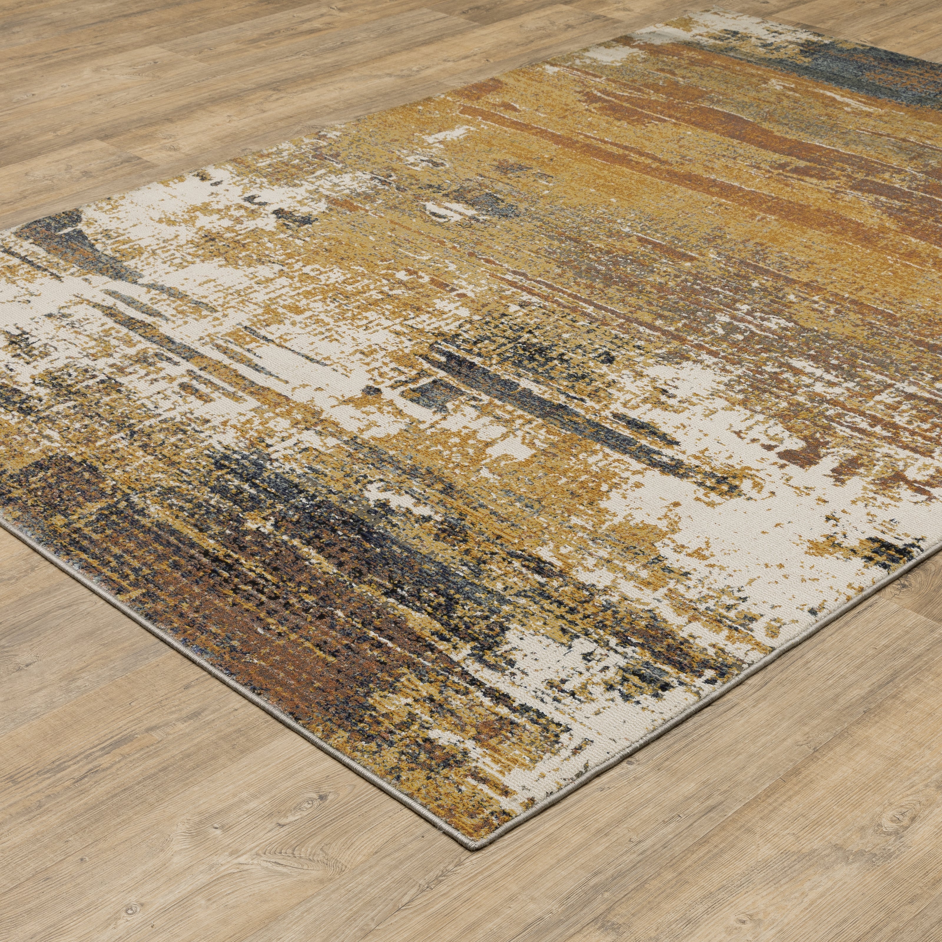 Distressed gold and cream abstract rug with vintage texture and weathered pattern design