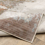 Modern distressed area rug with cream, brown, and green abstract texture pattern