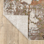 Modern distressed area rug with cream, brown, and green abstract texture pattern
