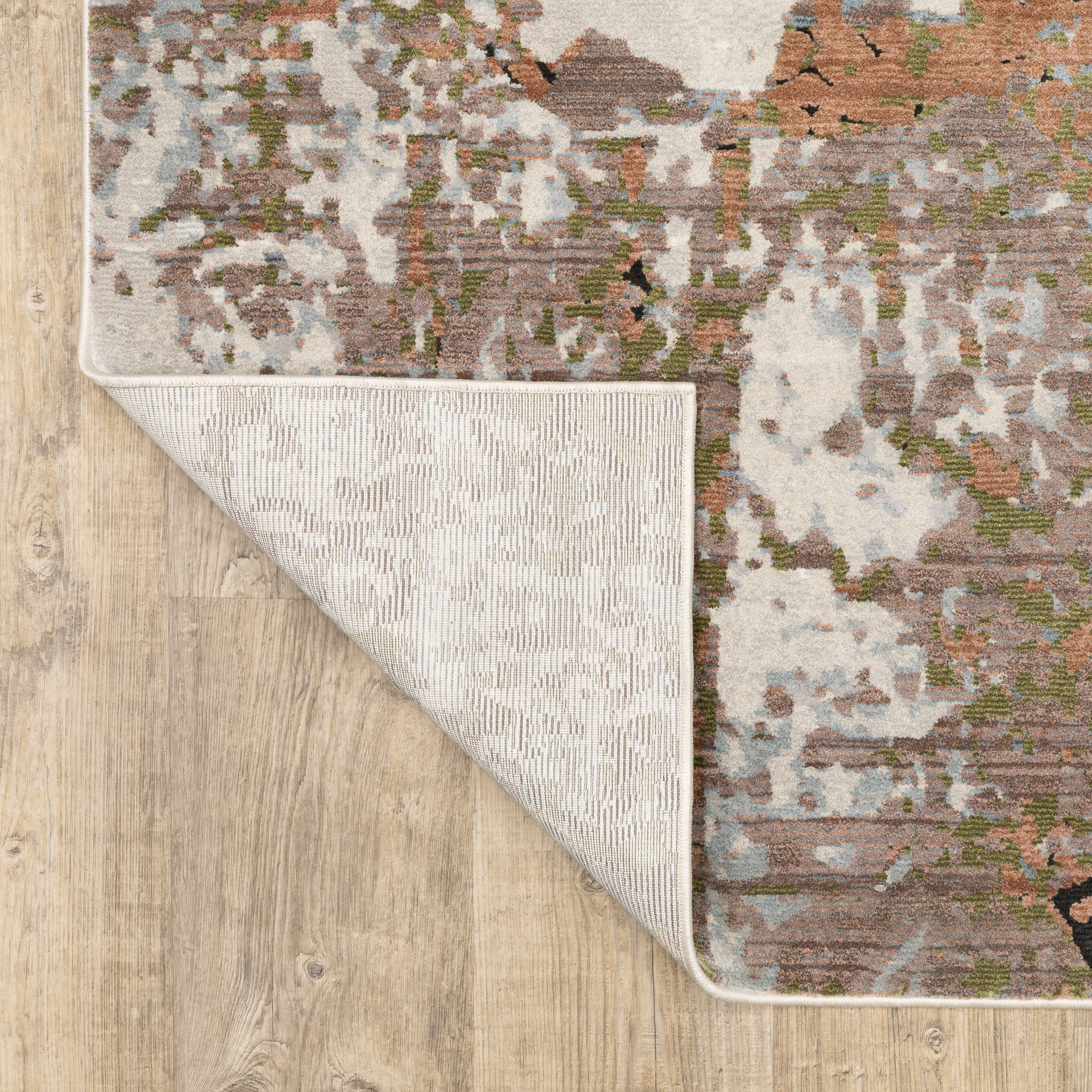Modern distressed area rug with cream, brown, and green abstract texture pattern
