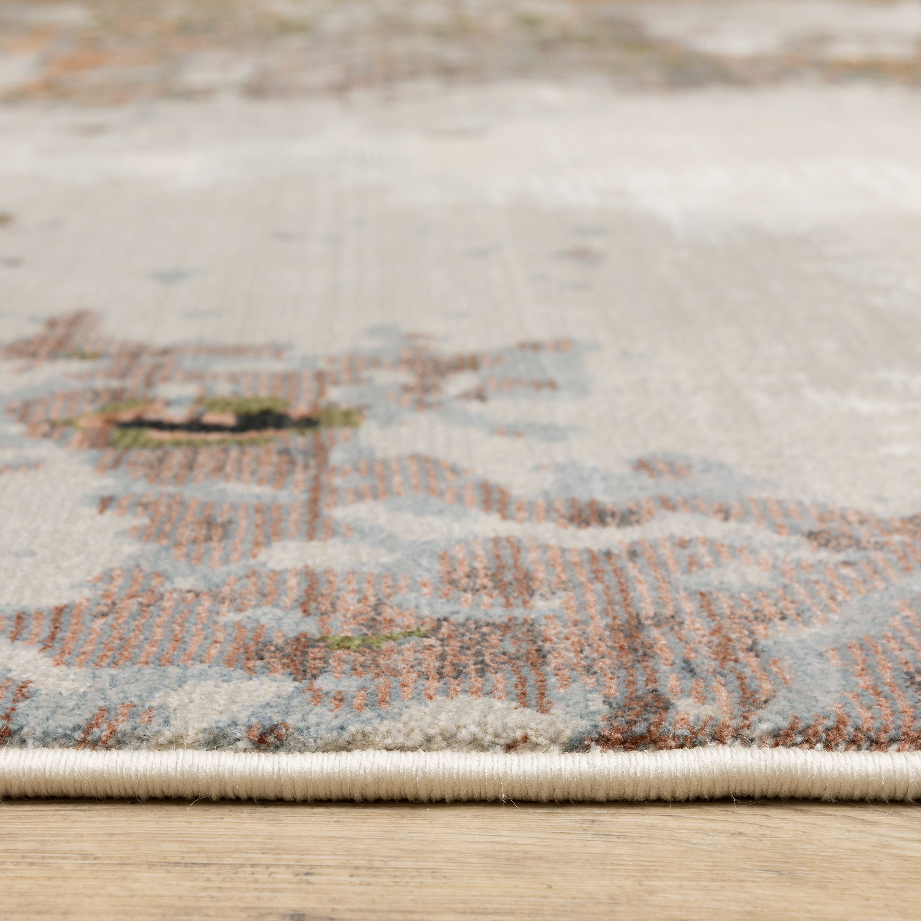 Modern distressed area rug with cream, brown, and green abstract texture pattern