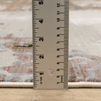 Modern distressed area rug with cream, brown, and green abstract texture pattern