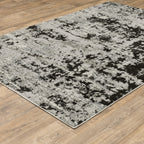 Distressed grey and black abstract textured area rug with worn vintage pattern