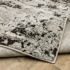 Distressed grey and black abstract textured area rug with worn vintage pattern