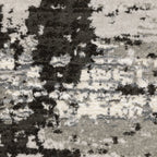 Distressed grey and black abstract textured area rug with worn vintage pattern