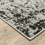 Distressed grey and black abstract textured area rug with worn vintage pattern