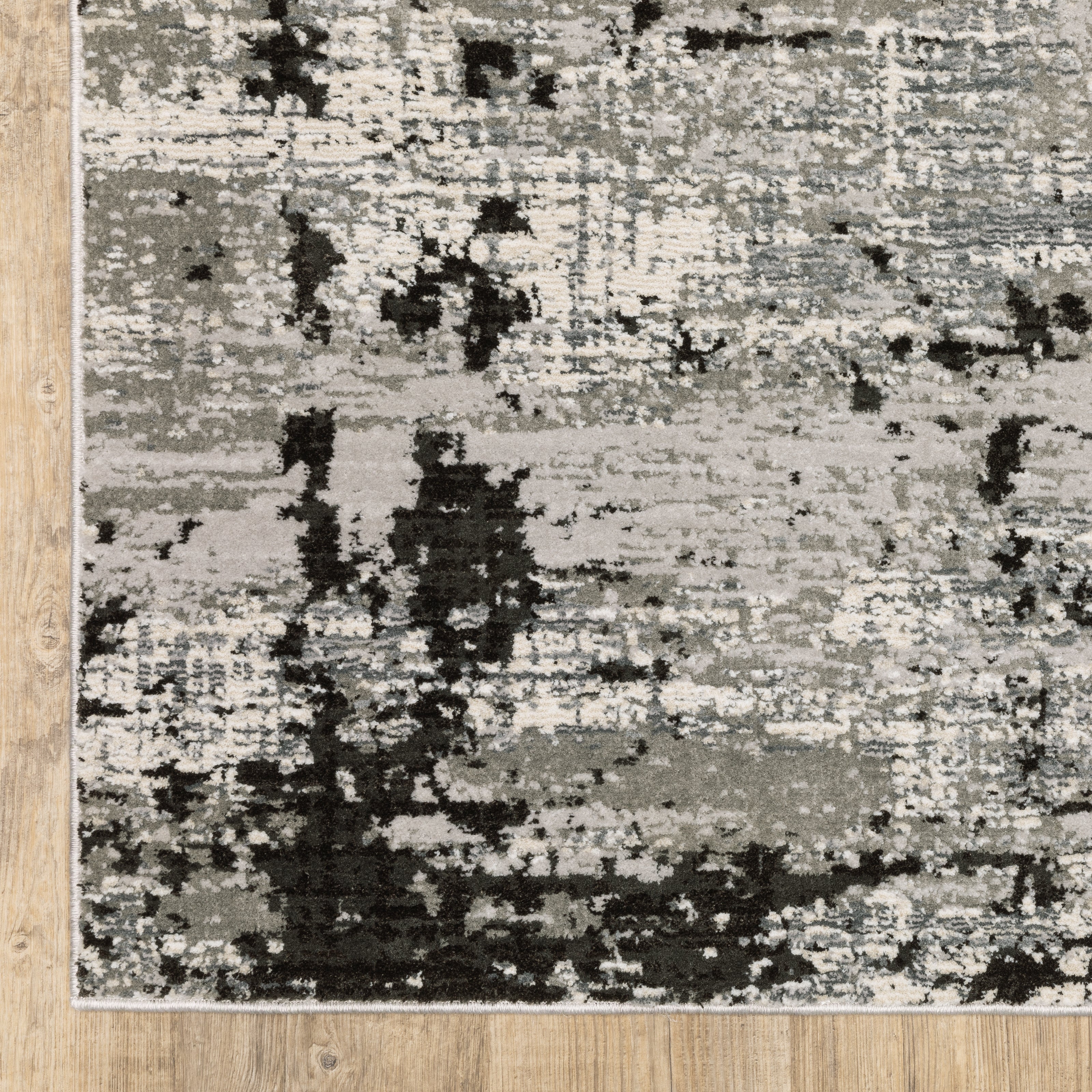 Distressed grey and black abstract textured area rug with worn vintage pattern