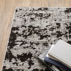 Distressed grey and black abstract textured area rug with worn vintage pattern