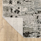 Distressed grey and black abstract textured area rug with worn vintage pattern