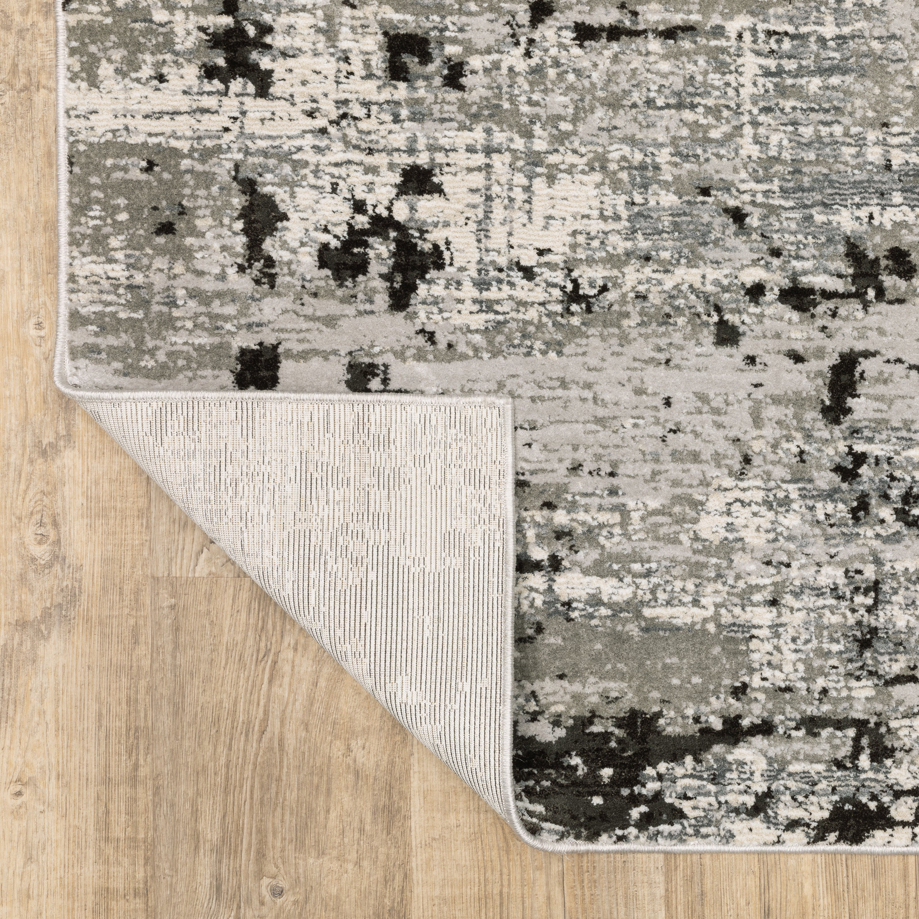 Distressed grey and black abstract textured area rug with worn vintage pattern