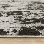 Distressed grey and black abstract textured area rug with worn vintage pattern