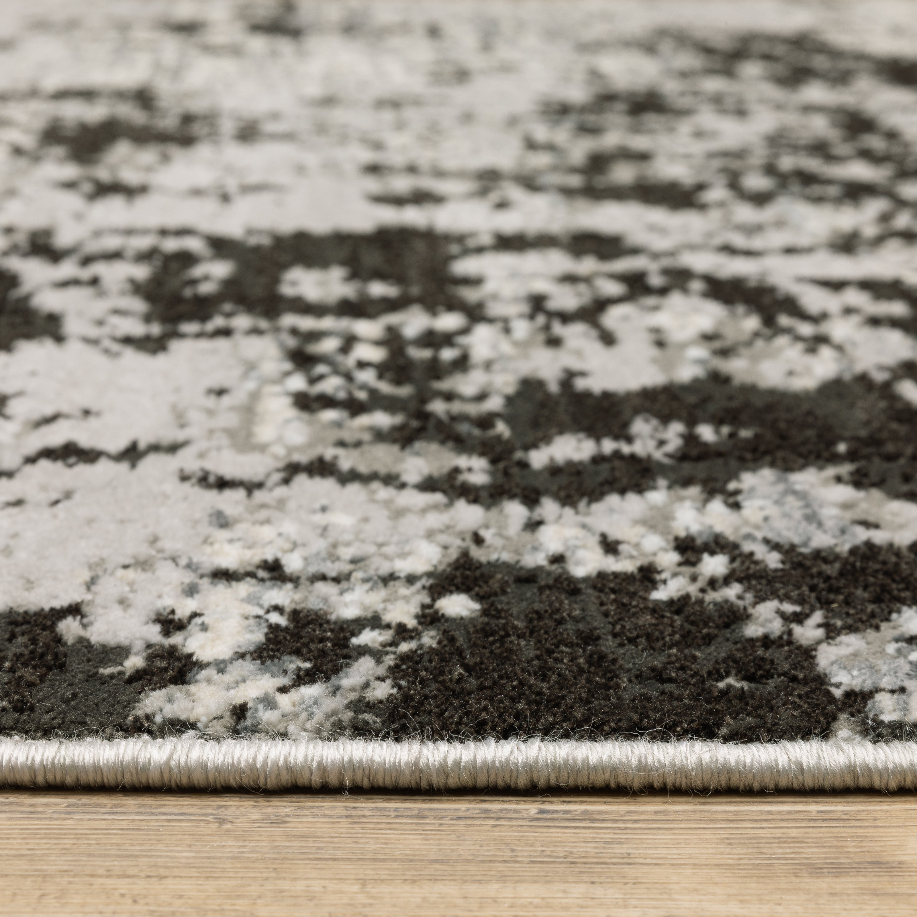Distressed grey and black abstract textured area rug with worn vintage pattern