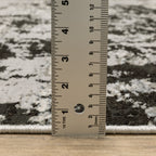 Distressed grey and black abstract textured area rug with worn vintage pattern