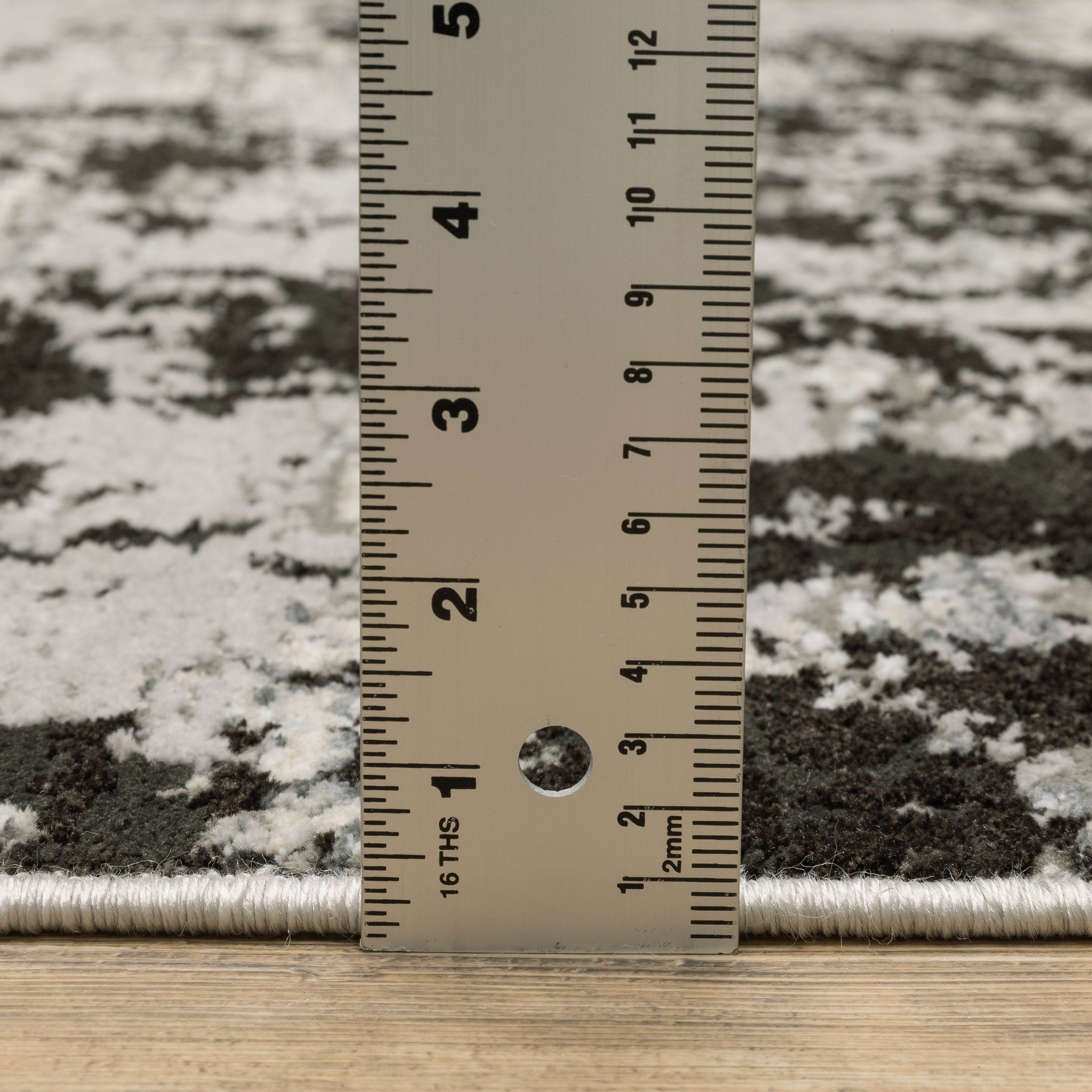 Distressed grey and black abstract textured area rug with worn vintage pattern