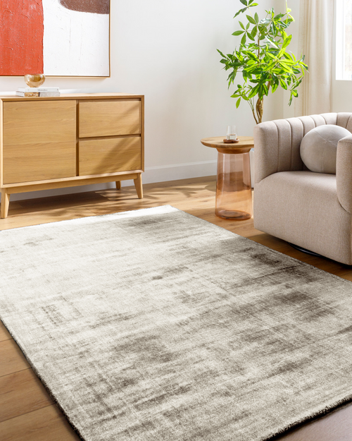 Amara viscose hand-loomed area rug in Ivory White, styled in a living room