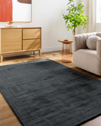 Dark grey distressed wool rug with subtle texture and mottled finish