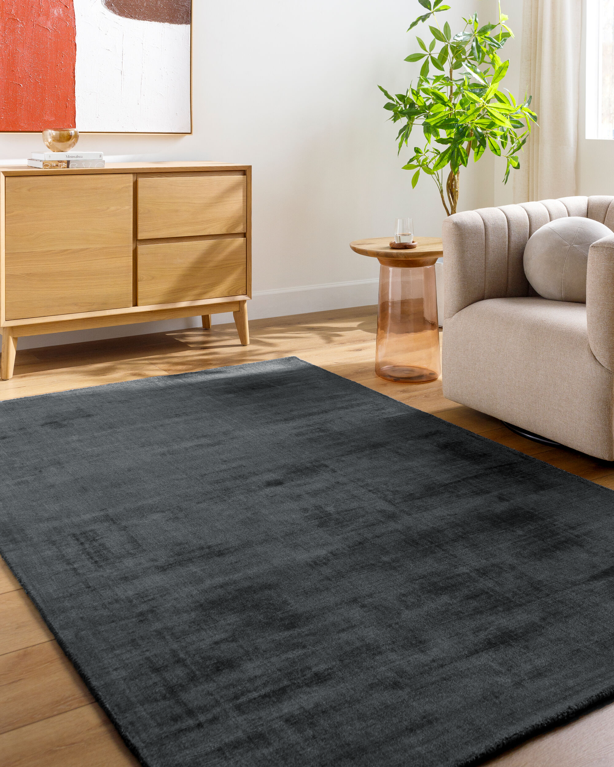 Dark grey distressed wool rug with subtle texture and mottled finish