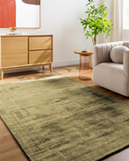 Distressed gold and charcoal textured area rug with abstract worn finish