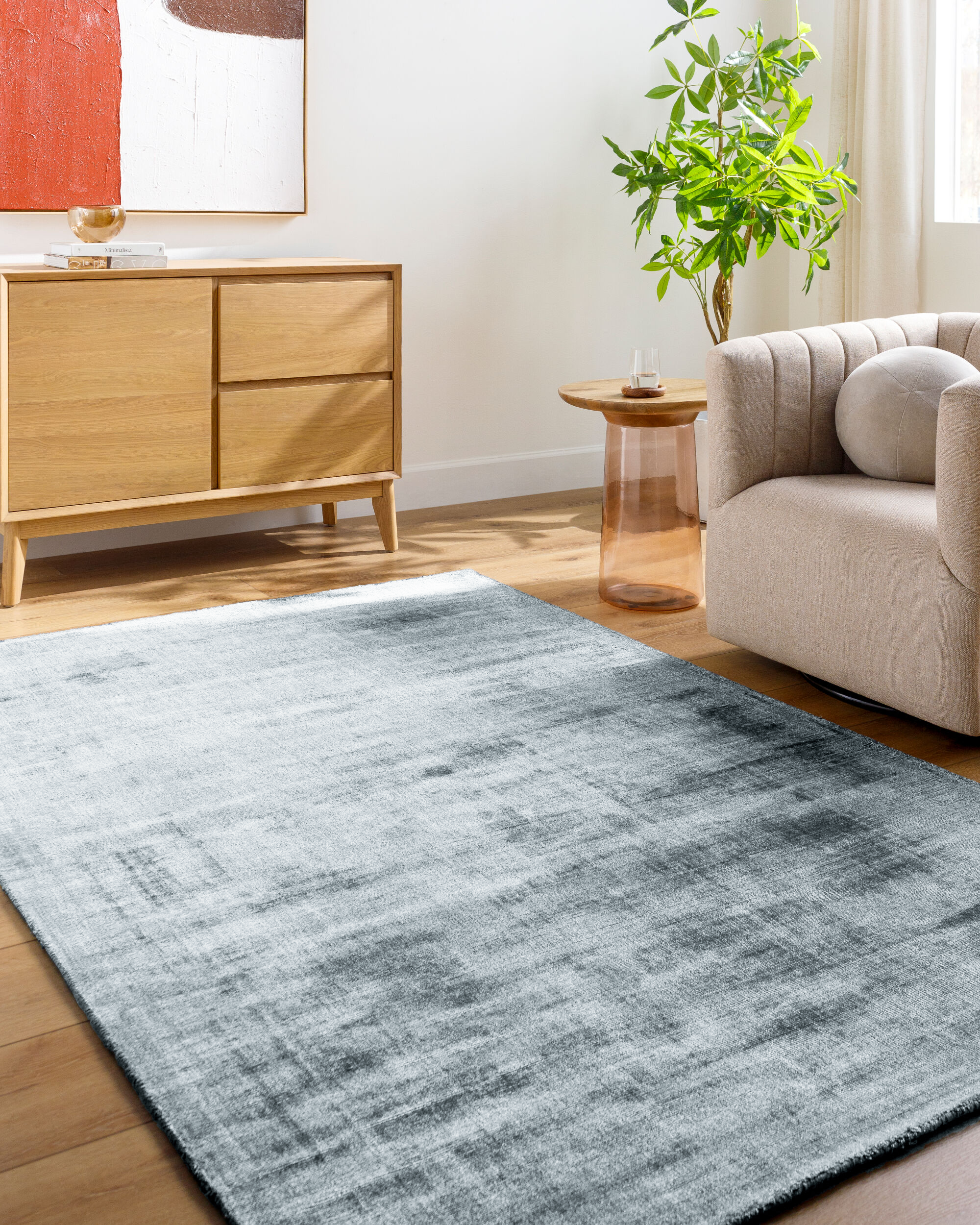 Light blue textured area rug with subtle grey distressed pattern and worn finish