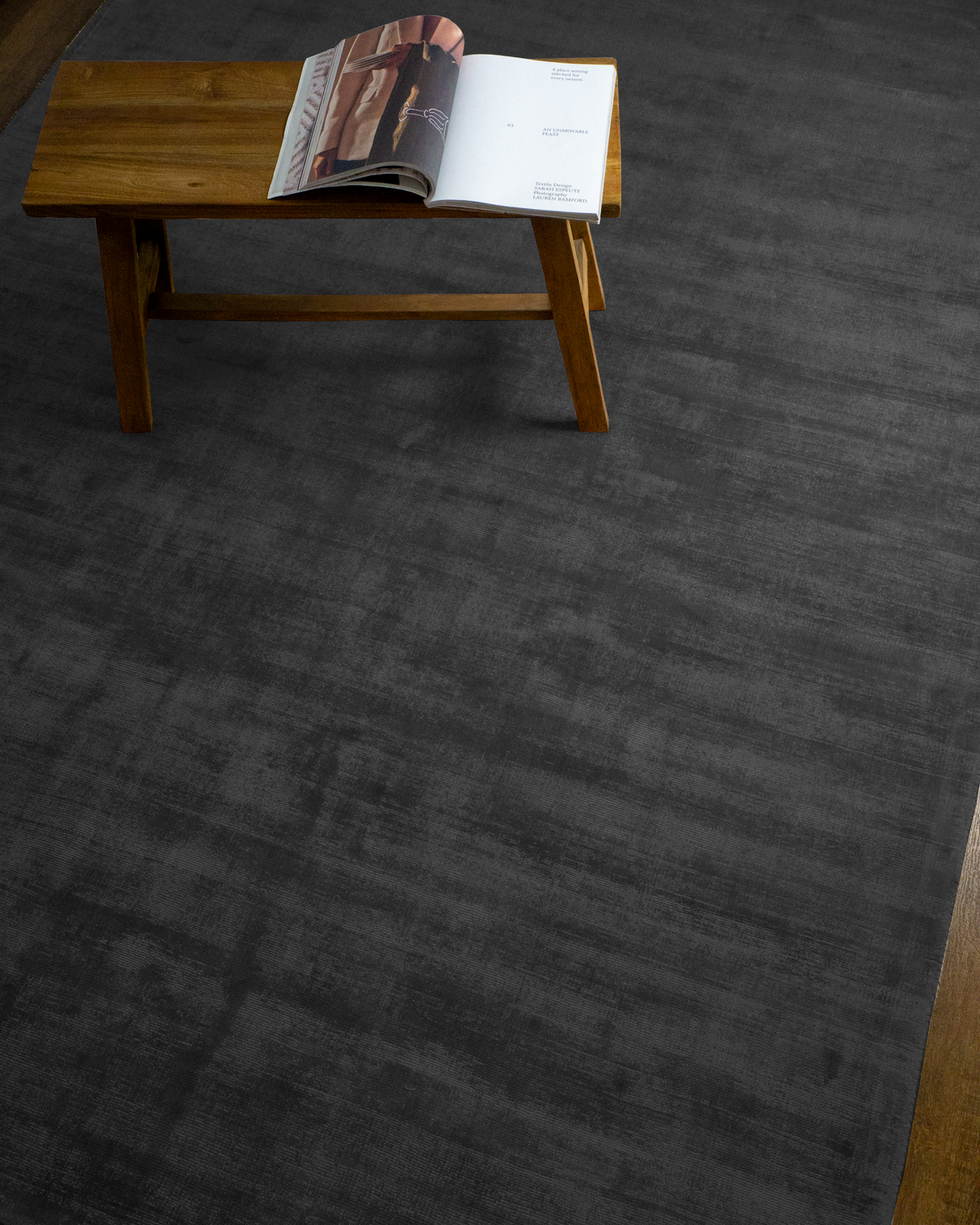 Amara viscose hand-loomed area rug in Navy Black, styled in a living room