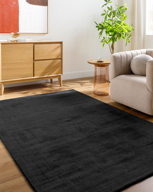 Dark charcoal grey distressed wool rug with subtle texture pattern