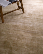 Beige textured rug with subtle horizontal striations and soft woven finish